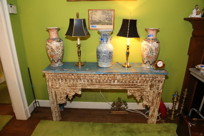 What a conversation piece!!! This lovely antique designer console table originated in India. The ornate hand carved panel in the front was recycled from another vintage piece of Indian furniture. The blue rustic top and legs were recycled from an old fishing boat. (Note that this piece is not something you would pickup at HomeGoods, Pier One Imports or Cost Plus World Market. It's a much finer piece of furniture and was purchased as a display piece for the store.) Please note, LOCAL pickup in Atlanta Georgia only. The retail price is $1,575.00

Item measures approximately: 57.2" long, x 13.3/4" deep x 30.5" tall 