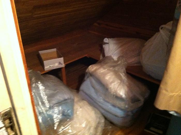 A variety of bedding kept in a pleasant-smelling cedar closet.