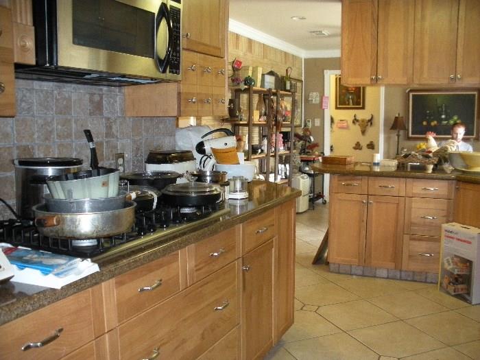 Counters are full, includes, vintage 1930's mix-master, pots/pans small appliances, etc