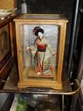 Japanese doll in case.