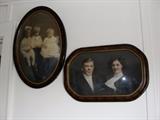 Vintage curved glass frames with hand colored photographs.
