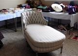 Comfy chaise lounge. Vintage linens, hats.