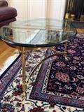 Modern glass top brass coffee table with hooved feet