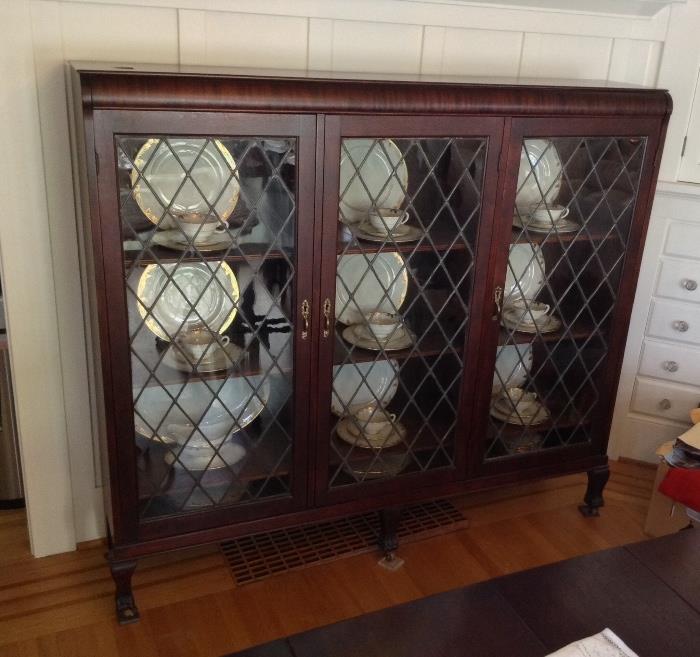 Antique mahogany triple door leaded glass bookcase (60" long, 53.5" tall & 12.5" deep)  Interior shelves are adjustable & have plate rail.  Note: China displayed inside cabinet is not for sale. Sorry!