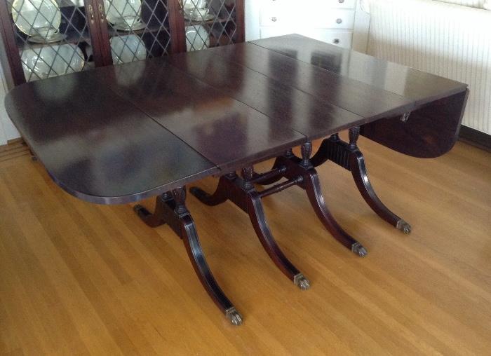 Duncan Phyfe mahogany drop leaf dining table.  Finish on the top is PERFECT - it just looks odd in photo due to reflection & glare.  Table extends to 94" long with both end leaves up & 3 other leaves in place. (Total of 4 leaves)