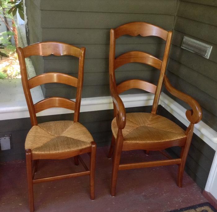 Two of a set of 5 country French style dining chairs with rush seats.  Set includes 3 side chairs & 2 with arms.