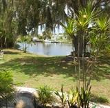 Backyard View of this Beautiful Waterfront Estate that is also for sale. The House sits on a large corner lot and has 2 sheds, (which were both full) Huge Oak Tree with Old Spanish Moss and a Pond with a Fountain 