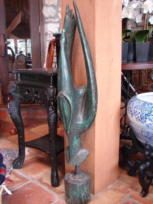 Bird sculpture waiting to be identified and priced. Carved table shown in background is ebonized and will make a great addition to home or office.