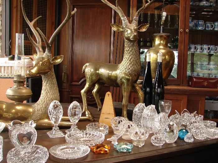 Collection of Waterford and other glass shown on Fischer baby grand piano. Thai brass deer will be for sale.