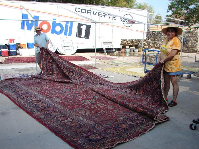 Terry and Eddie worked with Robert to roll out dozens of Persian and decorator rugs in the courtyard.