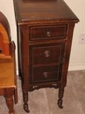 antique mahogany three drawer cabinet with wood casters