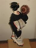 folk art Japanese geisha doll in ceremonial clothes