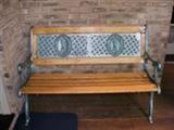 recently refurbished metal and wood outdoor bench
