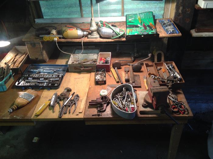Bench with tools, nails, wrenches,  etc