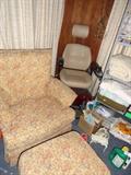 Behind the upholstered chair and ottoman is a battery operated wheel chair labeled "Golden Atlante"