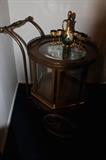 sorry for bad.. bad lighting!  really unique antique rolling cart.. entire round section spins and has storage inside