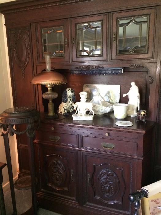 Intricately carved antique china cabinet; marble top plant stand