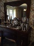 Antique buffet with beveled mirror; lots of silver plate serving pieces