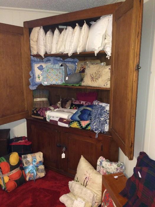 Large antique storage cabinet; many decorative pillows & linens
