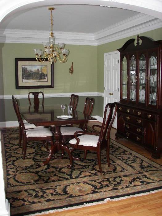 Queen Anne style pedestal table includes two leaves and protective pads. Six chairs. Two piece china cabinet which base along could be used as a sideboard serving table 