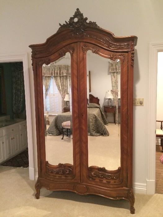 The extra large antique armoire can be used for storage or as an entertainment unit.