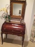 Elegant roll-top desk, mirror, and other decor