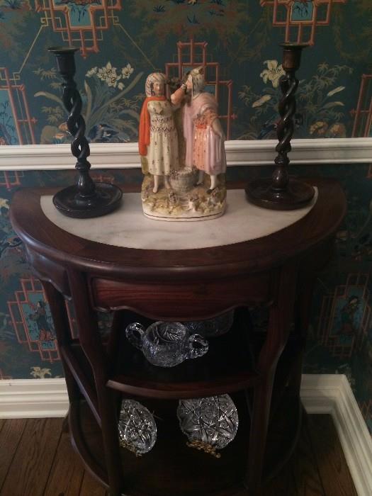 One of the several Staffordshire figures, barley twist candle holders, and demi-lune side table
