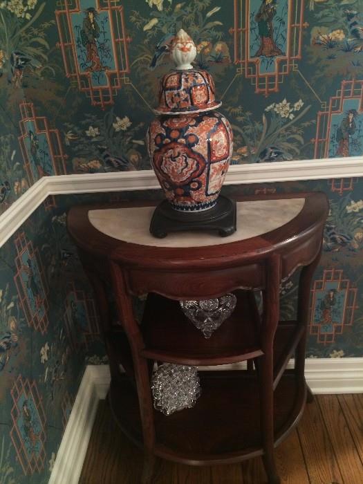 One of two marble top demi-lune side tables; Imari ginger jar and crystal pieces