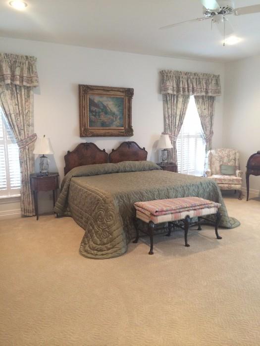 The lovely guest room is host to a beautifully burled wood king bed & oval shaped side tables.