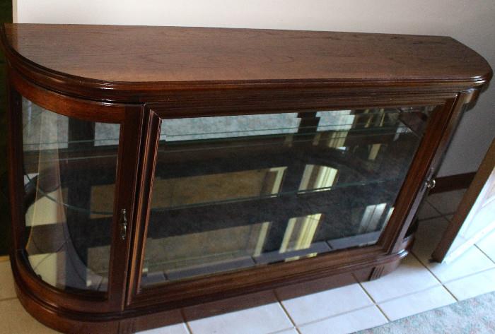 Foyer display cabinet/curio.  We like the curved sides so no one does bodily damage to themselves.