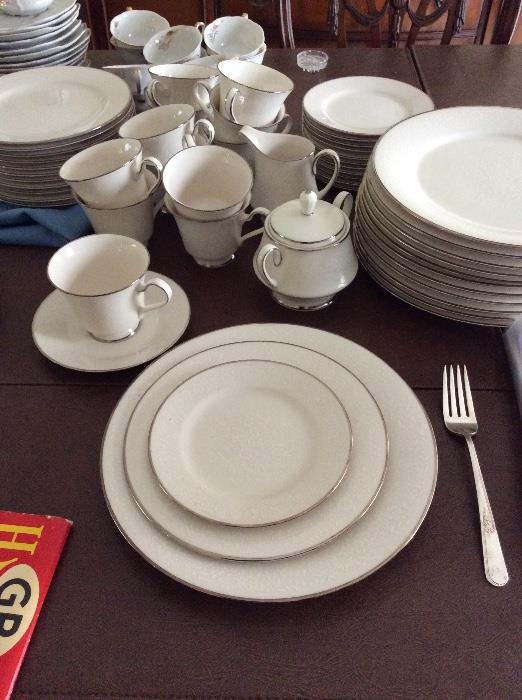 complete 12 piece china with serving accessories.  White on white embossed with sliver trim