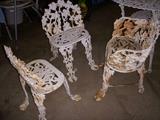 Cast iron chairs (one on the right with foot damage)