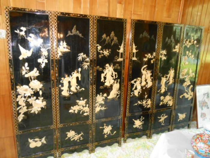 Multi panels hand decorated screens in sea shells on black lacquered background with brass.