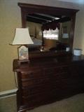 Sterling House Cherry Dresser with mirror. Measures 64"W X 34" H X 20" Deep, Mirror measures-39" Tall X 47" W 