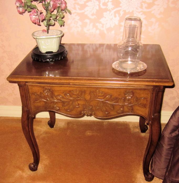 Small French, single-drawer table with carved front and sides. Made by Weiman.