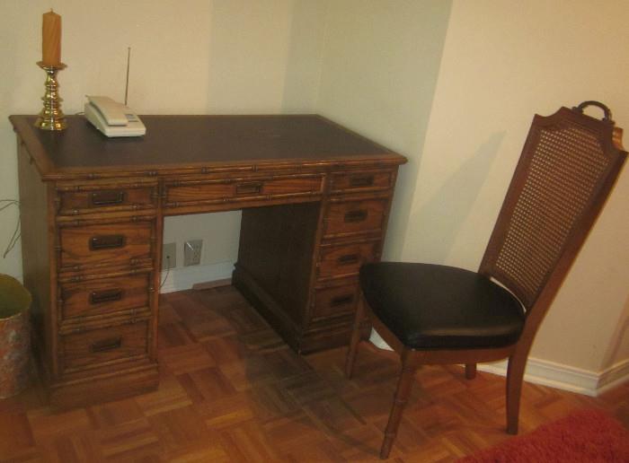 Faux bamboo desk made by Sligh Furniture, and matching cane backed chair. Desk is approximately  46" w; 23" d; 29.5" h.