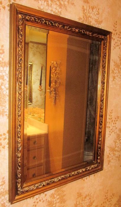 Magnificent,  ornately framed beveled mirror. Approximately 30" w; 45" h.