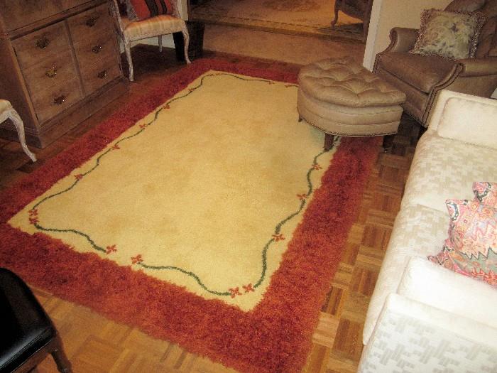 Unusual, custom made rug with shaggy border; Ivory colored center, edged with stylized floral motif.