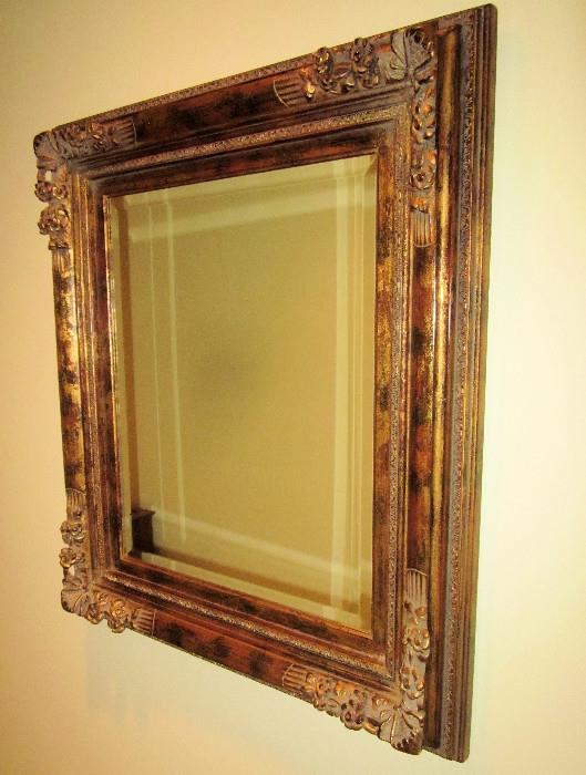 Beautiful, ornately framed beveled mirror. The flash creates the lines - there is not a problem with the mirror. Approximately 30" w; 33" h.