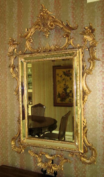 Beautiful, French mirror with beveled edge. The overall size is approximately 30" w; 50" h. The mirror frame is carved wood, and has a broken piece on the bottom edge, which needs to be re-attached. The photo shows the piece on a plate stand to illustrate the correct form of the mirror. The piece should be easily re-attached, and is available for the purchaser of the mirror.