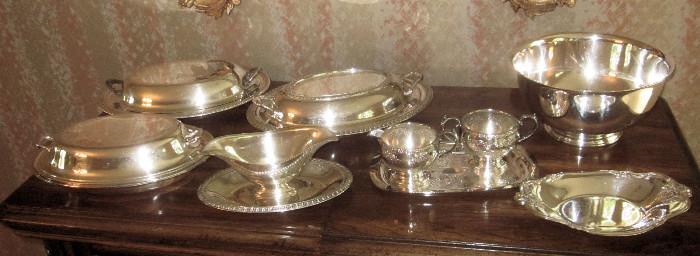 Variety of silver plate serving pieces.