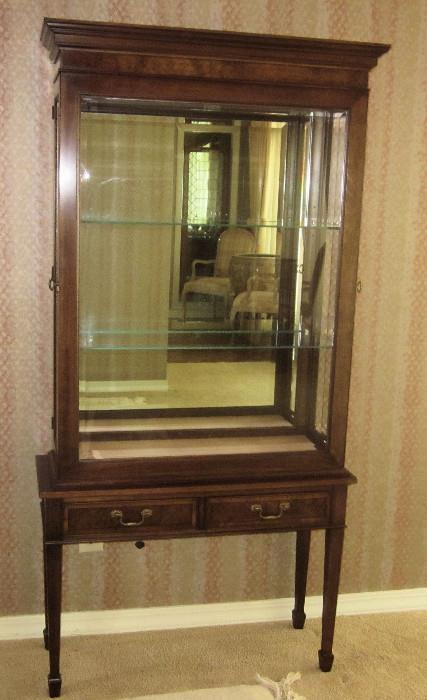 Stately Sheraton two-piece china cabinet; made by Hekman Furniture. Fabric-covered, removable, protective, interior bottom shelf insert. Adjustable glass shelving and mirrored back. Buffet portion has two drawers. 37" w; 14" d; 76" h.