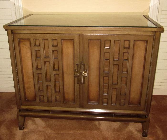 Walnut, oriental-style chest. Two doors open to access the three drawers. Custom glass top.