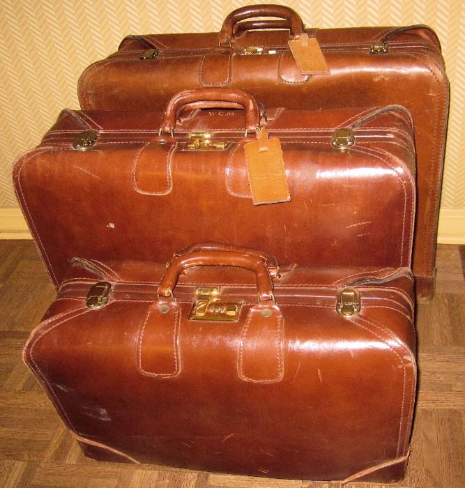 Three-piece set of leather vintage luggage.