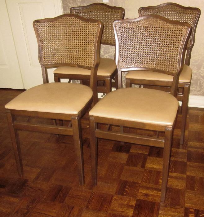 Wonderful set of 4 French, cane-back, folding chairs. Very sturdy and attractive. Excellent condition.