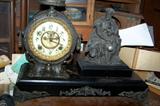 Beautiful metal case ship's wheel and figural clock--looks like an explorer.