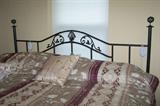 Metal headboard, king-size bed.