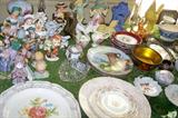 Tables full of glassware, china, figurines and collectibles.