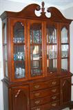 Large lighted cherry china cabinet, made by Dixie furniture, originally purchased inn 1980's. Filled with china and glassware.