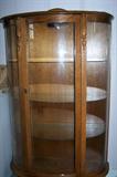 Late 20th century reproduction oak china cabinet--curved glass and lighted.